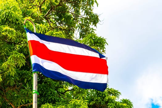 Costa Rican flag with blue sky background in Alajuela Costa Rica in Central America.