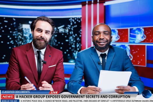 News about hackers revealing state secrets through classified documents discovered on servers, journalists team broadcasting live. Two reporters presenting government information exposed.