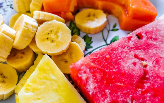 Plate with selected fruits papaya banana watermelon and pineapple in Alajuela Costa Rica in Central America.