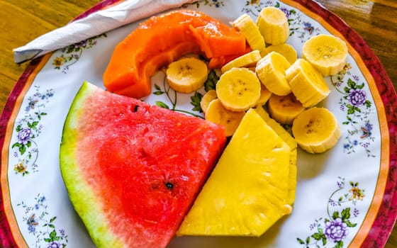 Plate with selected fruits papaya banana watermelon and pineapple in Alajuela Costa Rica in Central America.