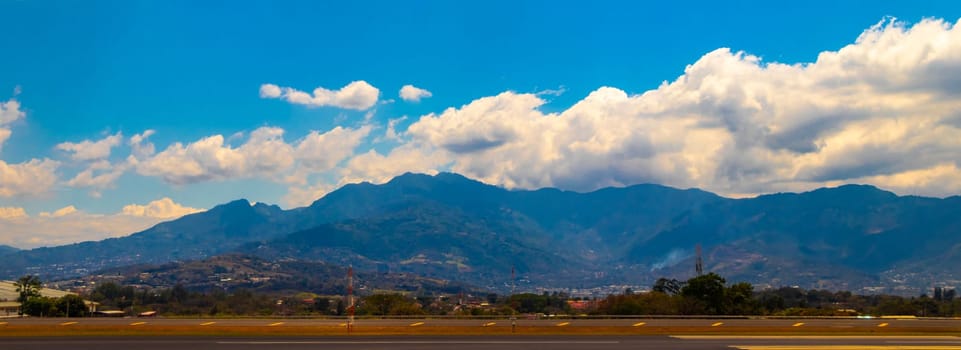 Runway airport and city mountains panorama view from airplane in Rio Segundo Alajuela Costa Rica in Central America.