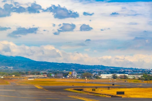 Runway airport and city mountains panorama view from airplane in Rio Segundo Alajuela Costa Rica in Central America.