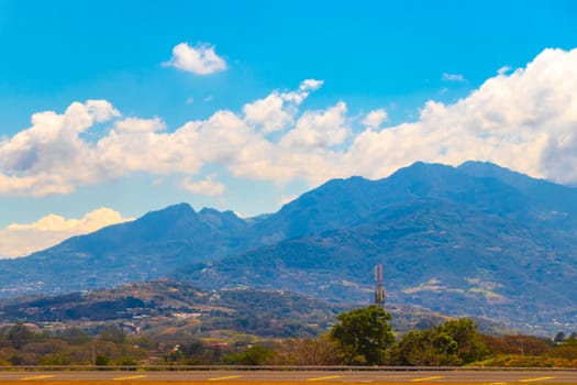 Runway airport and city mountains panorama view from airplane in Rio Segundo Alajuela Costa Rica in Central America.