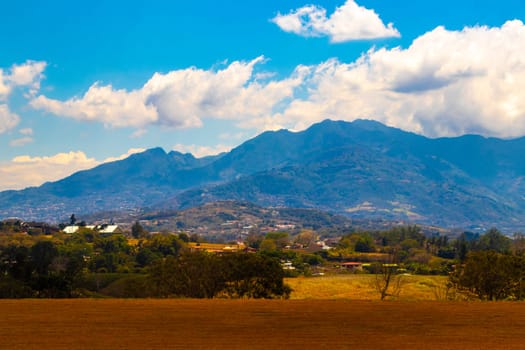 Runway airport and city mountains panorama view from airplane in Rio Segundo Alajuela Costa Rica in Central America.