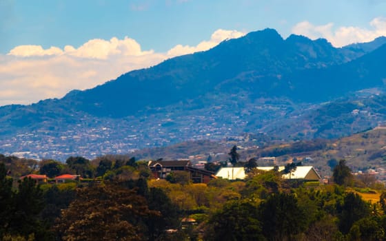 Runway airport and city mountains panorama view from airplane in Rio Segundo Alajuela Costa Rica in Central America.