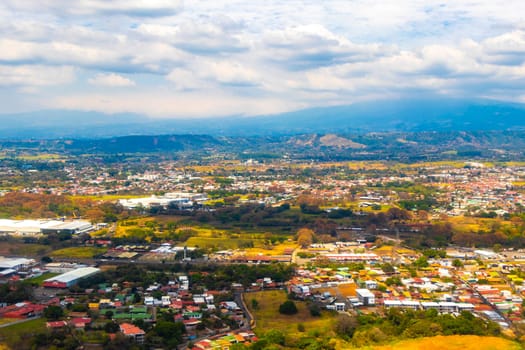 Runway airport and city mountains panorama view from airplane in Rio Segundo Alajuela Costa Rica in Central America.