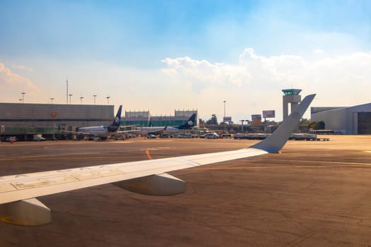 Aircraft at the airport Building and runway Aeropuerto Internacional Benito Juarez in Penon de los Banos Venustiano Carranza Mexico City Mexico.