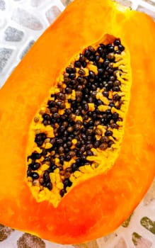 Half papaya in hand with background in Playa del Carmen Quintana Roo Mexico.