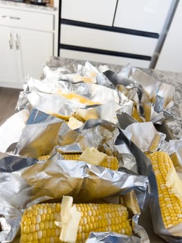 This image showcases fresh corn on the cob, neatly arranged in vacuum-sealed plastic packaging to preserve its freshness and flavor, ready for distribution or sale.