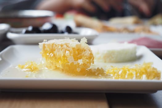 butter cream and honey in a bowl on table