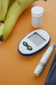 Close up of diabetic measurement tools and pills on pink background .