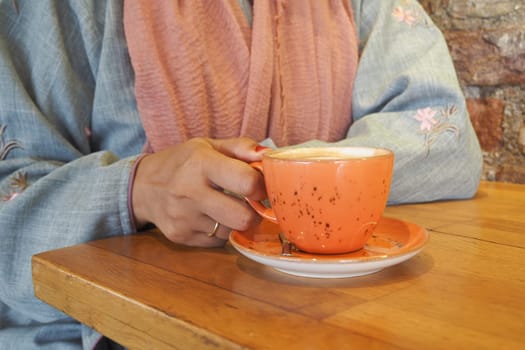 women holding a coffee cup .