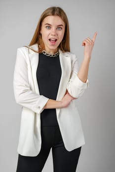 Excited Young Woman in Stylish Outfit Surprised Expression in Studio