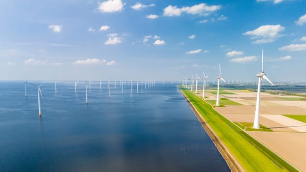 A mesmerizing overhead view captures the graceful dance of windmill turbines in a vast oceanic wind farm, located in the Netherlands Flevoland.
