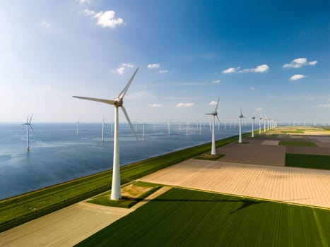 Serene wind farm in Flevoland, the Netherlands. Rows of majestic windmills gracefully turning in harmony, harnessing the power of the wind to generate renewable energy.
