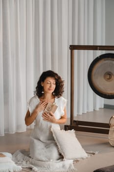 A woman in white clothes holds an envelope with a wish in her hands. The concept of a women's circle.