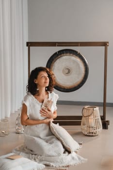 A woman in white clothes holds an envelope with a wish in her hands. The concept of a women's circle.