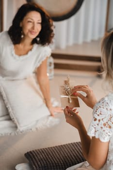 A woman in white clothes holds an envelope with a wish in her hands. The concept of a women's circle.