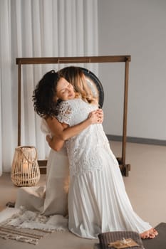 Two women hug at yoga. Women's Circle.