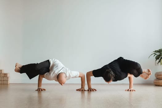 two young athletes practice yoga in the gym. Joint training, indoors, studio. The concept of a healthy lifestyle.