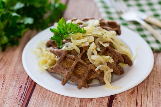 fried liver waffles with onions and herbs .