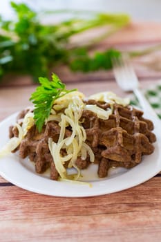 fried liver waffles with onions and herbs .