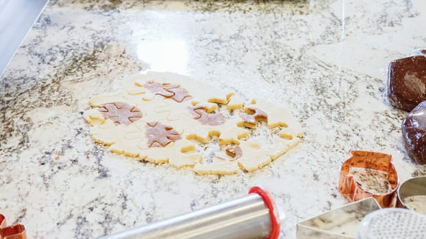 Using various festive cookie cutters, we're cutting out charming gingerbread cookies from the rolled dough on the sleek marble counter, bringing holiday cheer to the modern kitchen.