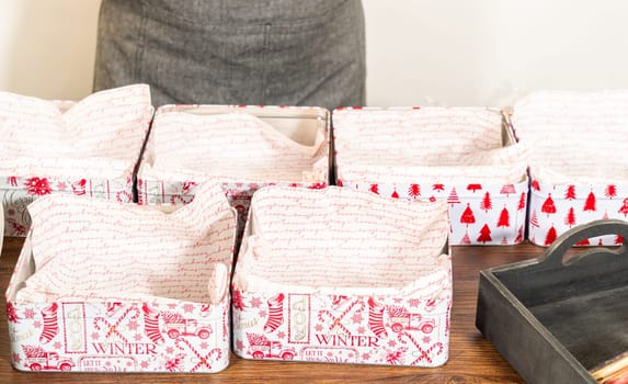 Lovingly homemade gingerbread and sugar cookies, half-dipped in rich chocolate, nestled in decorative Christmas tin boxes perfect for seasonal gifting.