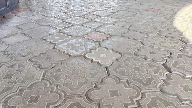 Paving slabs. Background, texture. Sun-drenched patterned paving with subtle color variations