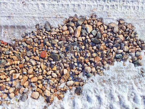 Small pebbles in the snow as background and texture. Heart-Shaped Rock Arrangement on Wall. Background, texture, pattern, frame, copy space