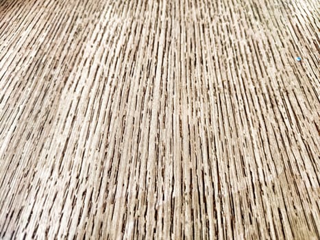 Textured Wooden Surface Detail Captured in Natural Light. Close-up of the intricate grain pattern on wooden surface.