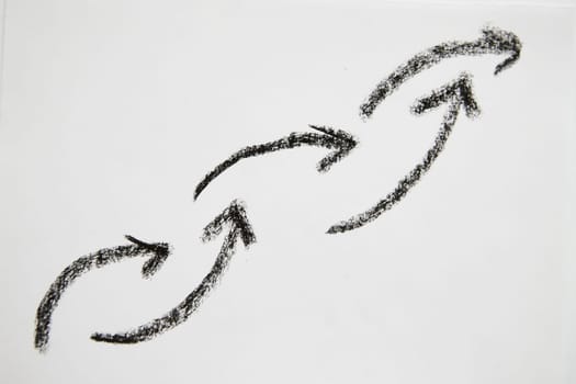 Many graceful smooth Hand drawn black chalk arrows like a chain. Concept of business, choosing direction, moving forward. Abstract sign, background, texture. Blurred