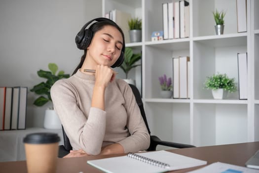 Unhappy Asian businesswoman showing stress over unsuccessful business in Home Office.