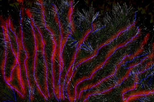 existing in thought or as an idea but not having a physical or concrete existence. Shiny tree fir pine branches with abstract glowing red and blue stripes. High quality photo