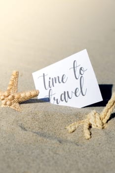 TIME TO TRAVEL text on paper greeting card on background of starfish seashell summer vacation decor. Sandy beach sun coast. Holiday concept postcard. Getting away Travel Business concept