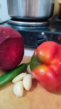 sweet red pepper, beets, garlic, green hot pepper, vegetables food in the kitchen, stove. High quality photo