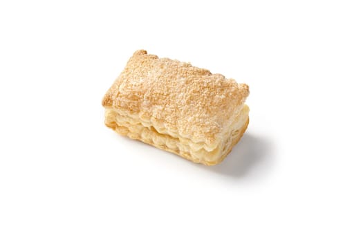 Close-up of freshly baked, golden brown cream puff pastry, generously sprinkled with sugar, presented on white background, perfect for sweet teatime treat