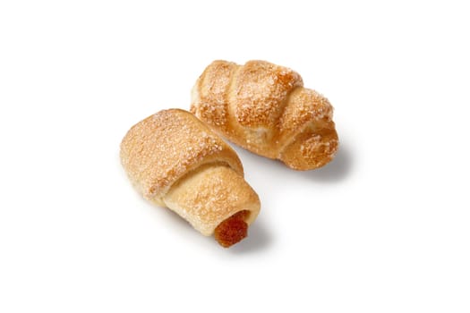 Two small crispy and flaky buttery puff pastry turnovers with delicate cinnamon flavored apple confiture filling and golden crust of sugar sprinkles. Popular baked goods