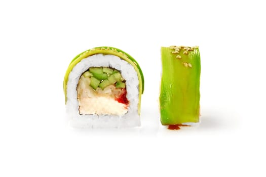Closeup of appetizing sushi roll filled with tempura perch, cream cheese, cucumber and tobiko roe wrapped in thin avocado slices, isolated on white background