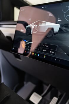 Denver, Colorado, USA-May 5, 2024-The interior of a Tesla Cybertruck is highlighted in this image, showcasing the modern and minimalist dashboard with its large touchscreen display and distinctive steering yoke, providing a glimpse into the future of automotive design.