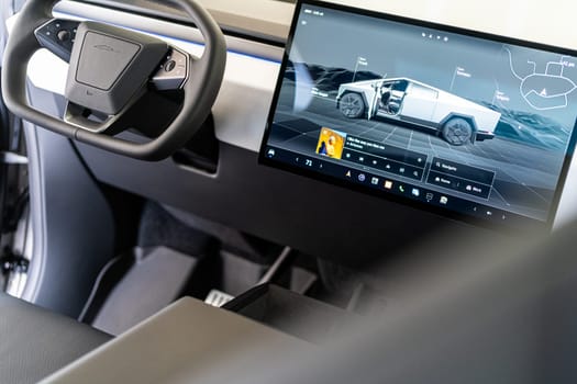 Denver, Colorado, USA-May 5, 2024-The interior of a Tesla Cybertruck is highlighted in this image, showcasing the modern and minimalist dashboard with its large touchscreen display and distinctive steering yoke, providing a glimpse into the future of automotive design.