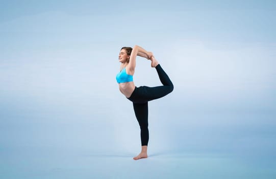 Full body length gaiety shot athletic and sporty woman doing healthy and meditative yoga exercise workout posture on isolated background. Healthy active and body care lifestyle