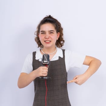 With microphone in a hand positive teenage girl singer, young karaoke singer hold microphone.