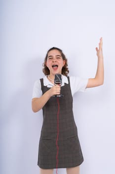 With microphone in a hand positive teenage girl singer, young karaoke singer hold microphone.