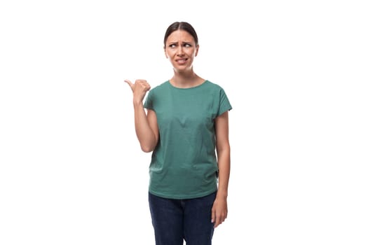 pretty young brunette woman in green t-shirt has doubts and looks away.