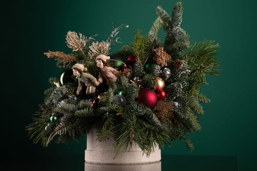 A woven basket brimming with various Christmas decorations sits atop a wooden table. The decorations include ornaments, garlands, lights, and figurines, creating a festive and cozy atmosphere.