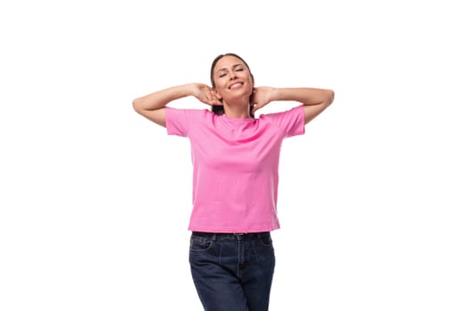 young beautiful model woman with straight black hair dressed in a pink t-shirt happy.