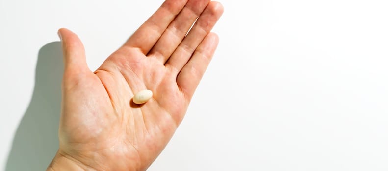 Design Progesterone Pill, Capsules In Human Hand On White Background. Dose Of Medications Treats Irregular Menstrual Cycle, Fertility Treatments, Menopausal Hormone Therapy, Horizontal Copy Space.