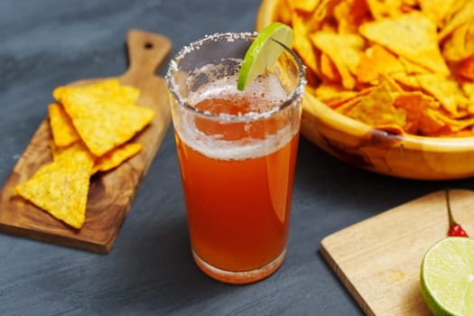 Michelada, Mexican alcoholic cocktail with beer, lime juice, tomato juice