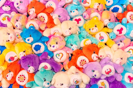 tokyo, japan - apr 16 2024: Bunch of plushies of multi-colored Care Bears adorned with cute belly badge or tummy symbol for each one like heart, sun, cup cake, moon, rainbow created by Elena Kucharik.